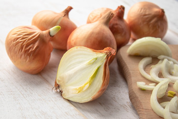 Sliced fresh onions on wooden background. Vegetables for a healthy diet. Vegan food.