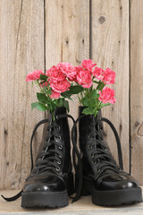 Bunch of flowers in black combat boots