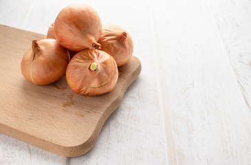 Fresh onion on wooden background. Ripe onions Allium cepa or onions or vegetarian and vegan food.