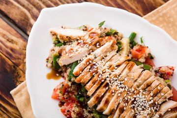 healthy salad with quinoa, vegetables and grilled chicken