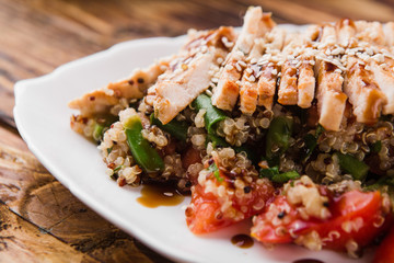 healthy salad with quinoa, vegetables and grilled chicken