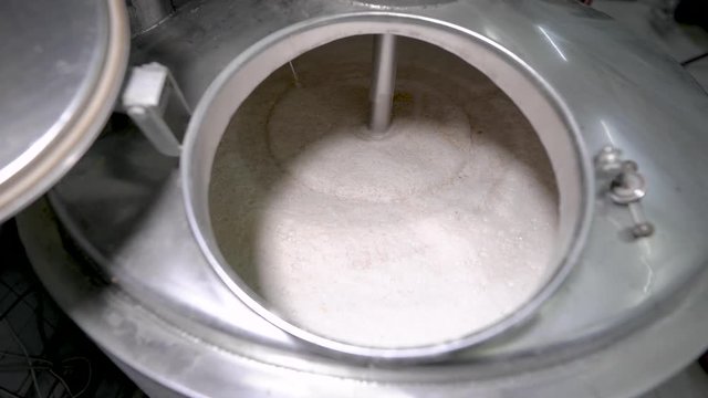 Beer Slowly Rotating in a Large Container 