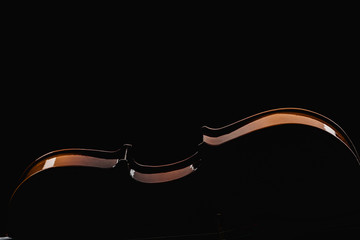 close up of wooden violoncello in darkness isolated on black © LIGHTFIELD STUDIOS