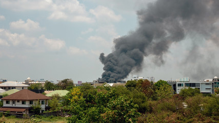 Black smoke groups caused by fire that is burning buildings or houses.