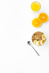 Healthy granola and orange juice for colorful breakfast on white background top view mock-up