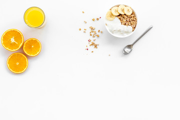 Healthy granola and orange juice for colorful breakfast on white background top view mock-up