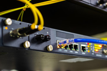 Network switch in rack, network cables connect SFP module port in the Datacenter room, concept Communication technology