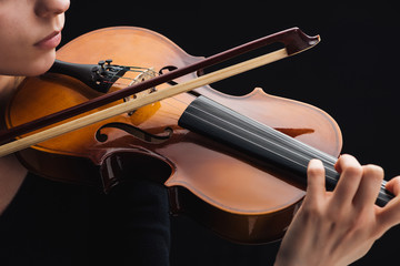cropped view of woman playing cello with bow isolated on black