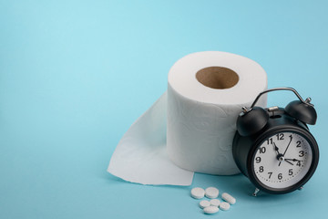 Toilet paper, pills and clock