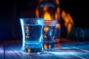 Two shots of vodka in the multiple bar lights
