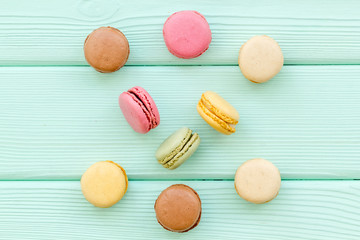 Macarons dessert pattern on mint green background top view