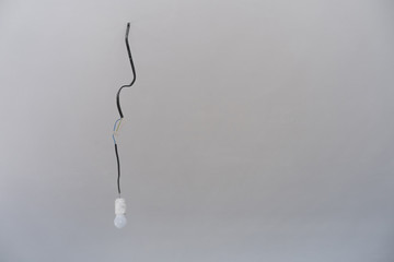 light bulb hanging on the wire in the white room