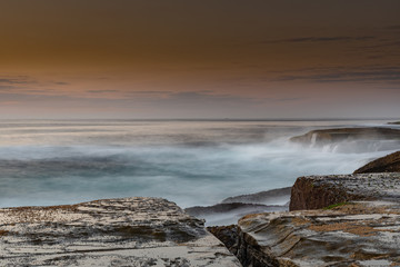 Rock Platform Sunrise Seascape with Light Smattering of Clouds