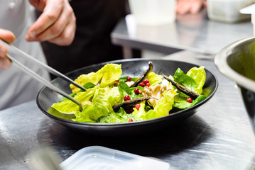 chef making salad in the restaurant