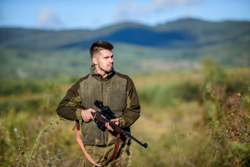 Bearded hunter spend leisure hunting. Hunter hold rifle. Focus and concentration of experienced...