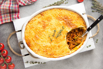 Shepherds pie with a brown crust, meat tomato stew with green peas and mashed potatoes with cheese. Delicious food, home cooking