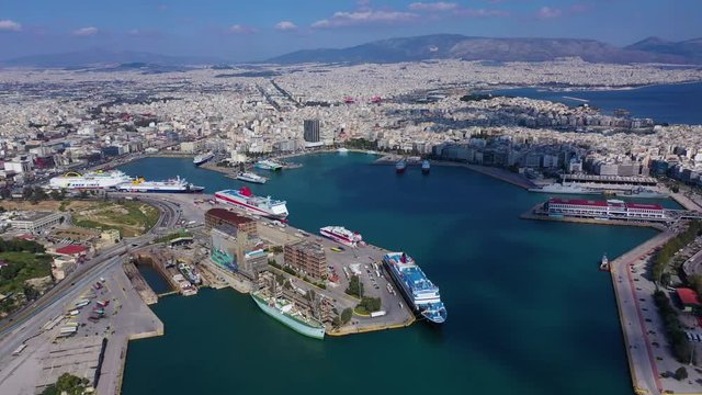 Aerial drone video of crowded port of Piraeus, one of the largest in Europe, where cruise and passenger ships travel to popular Aegean destinations, Attica, Greece