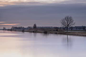 Fototapeta premium A quiet morning on the waters of Kinderdijk, Alblasserdam, the Netherlands