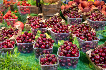 Sweet cherry on the counter of the stall in the food market.