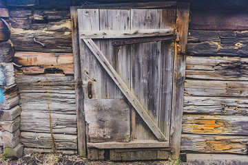 old wooden door of a collapsed barn.