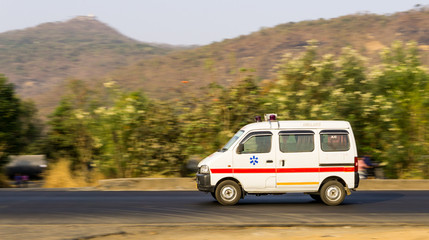 Fototapeta na wymiar An ambulance on an Indian road travelling at high speed near Mumbai suburban 