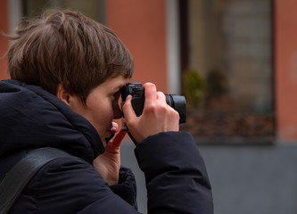 April 2019, Moscow, Russia.Girl photographer in profile.Photographs the streets of Moscow