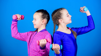 Happy children coach with barbell. Fitness diet for energy health. workout of small girls hold dumbbell. weight lifting for muscules. Childhood activity. Sport success. planning time with coach
