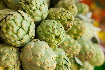 Fresh artichokes on market counter