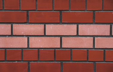 Obraz premium Brown brick wall background-vector.Brick wall red, red and two layers of beige brick in the middle.Background.Laying.Beige.Dark red.Brick.Brickwork. 