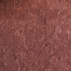OSB plate is made of red,brown pressed wood chips. Wood chips pressed together with resins. OSB plate painted in mahogany color.
