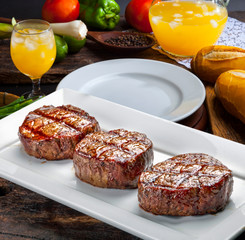 Three steaks roasted on the grill