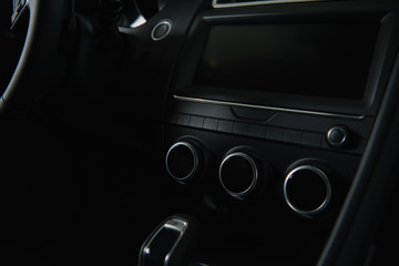 black buttons near modern car dashboard in automobile