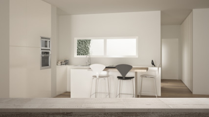 Wooden vintage table top or shelf closeup, zen mood, over contemporary minimalist white and wooden kitchen with island and stools, white architecture interior design