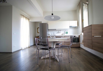 modern kitchen with furniture and table with chairs
