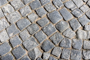 Fragment of an old granite pavement as the basis of the background. 