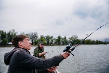 Fishermen catch fish sitting in the boat