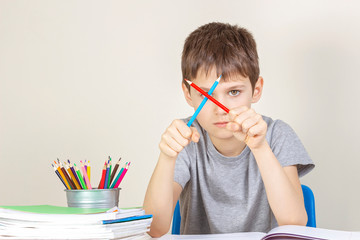 Sad angry boy have difficulties doing homework