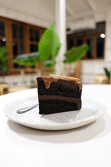 Chocolate cake with cinnamon stick in white table bright background.