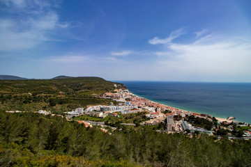 Fototapeta na wymiar aerial view of Sesimbra village with blue sky and clouds in background