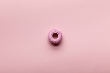 top view of cotton knitting yarn ball on pink with copy space