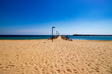 Pontoon on the beach with sand in the foreground