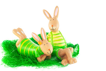hares sitting and lying on the grass on a white background