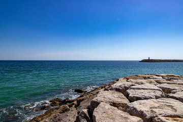 Pontoon rocks with the sea and blue sky in front