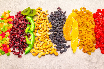 Dried and candied fruit and cashew nuts. Assorted on a stone background. Healthy vegetarian (vegan)...