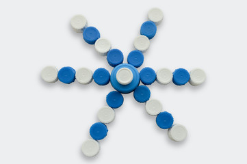 figure simulating a flower made of plastic caps isolate on white backgound