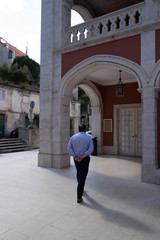 man walking on the street in front of the old house in Sintra