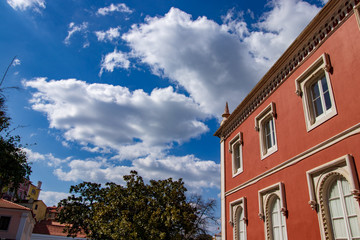 Fototapeta premium old house with blue sky and white clouds standing out above