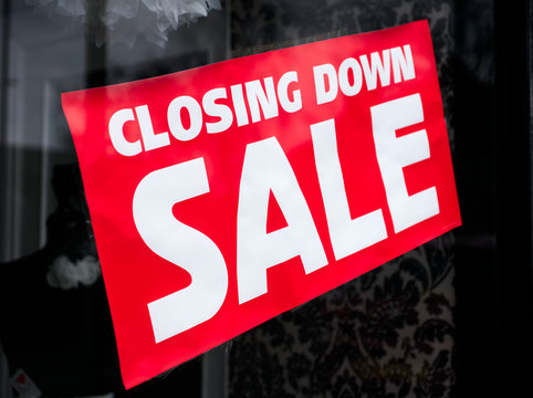 Closing down sale sign in shop store mall window