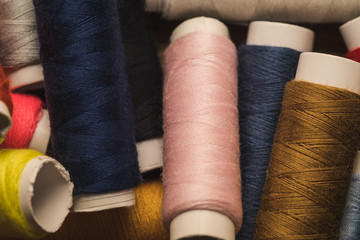 top view of scattered colorful cotton thread coils