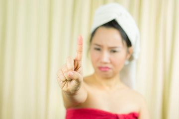 asian woman wear a skirt to cover her breast after wash hair, Wrapped in Towels After Shower and giving gesture sign, symbol with hands up.